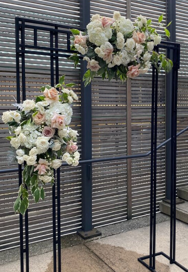 melrose flower lab wedding arch adorned with colorful flowers and lush greenery