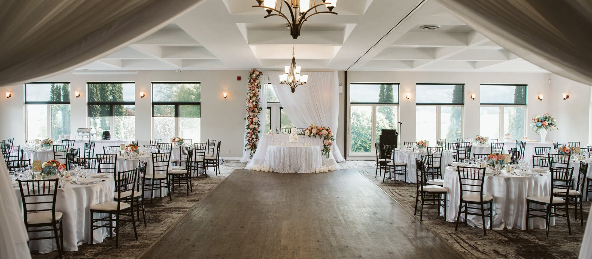 melrose flower lab wedding reception room with white drapes and chairs